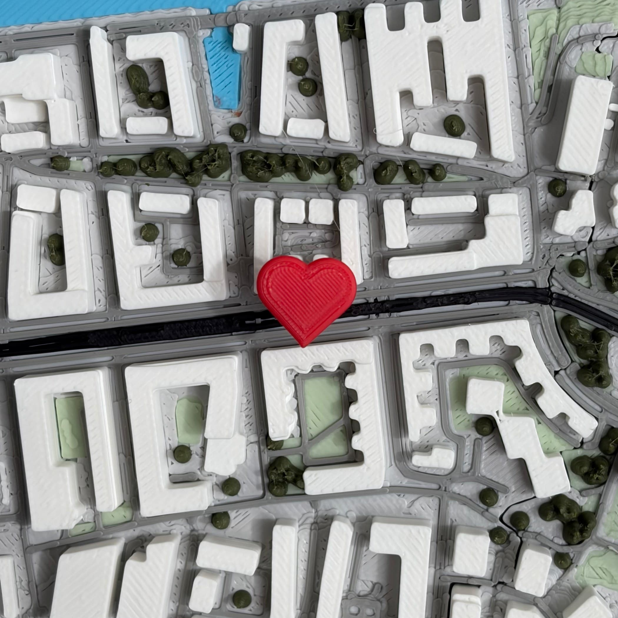 Small heart pin placed on a detailed 3D map.