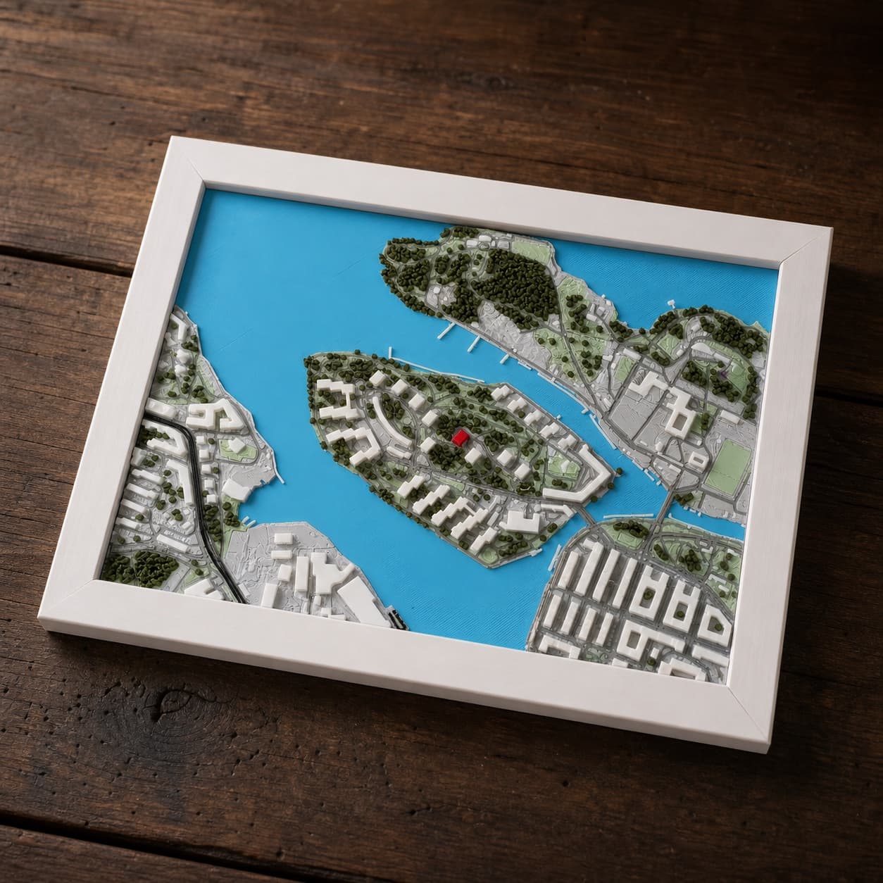 Close view of a detailed printed relief map showing roads, buildings, and water.