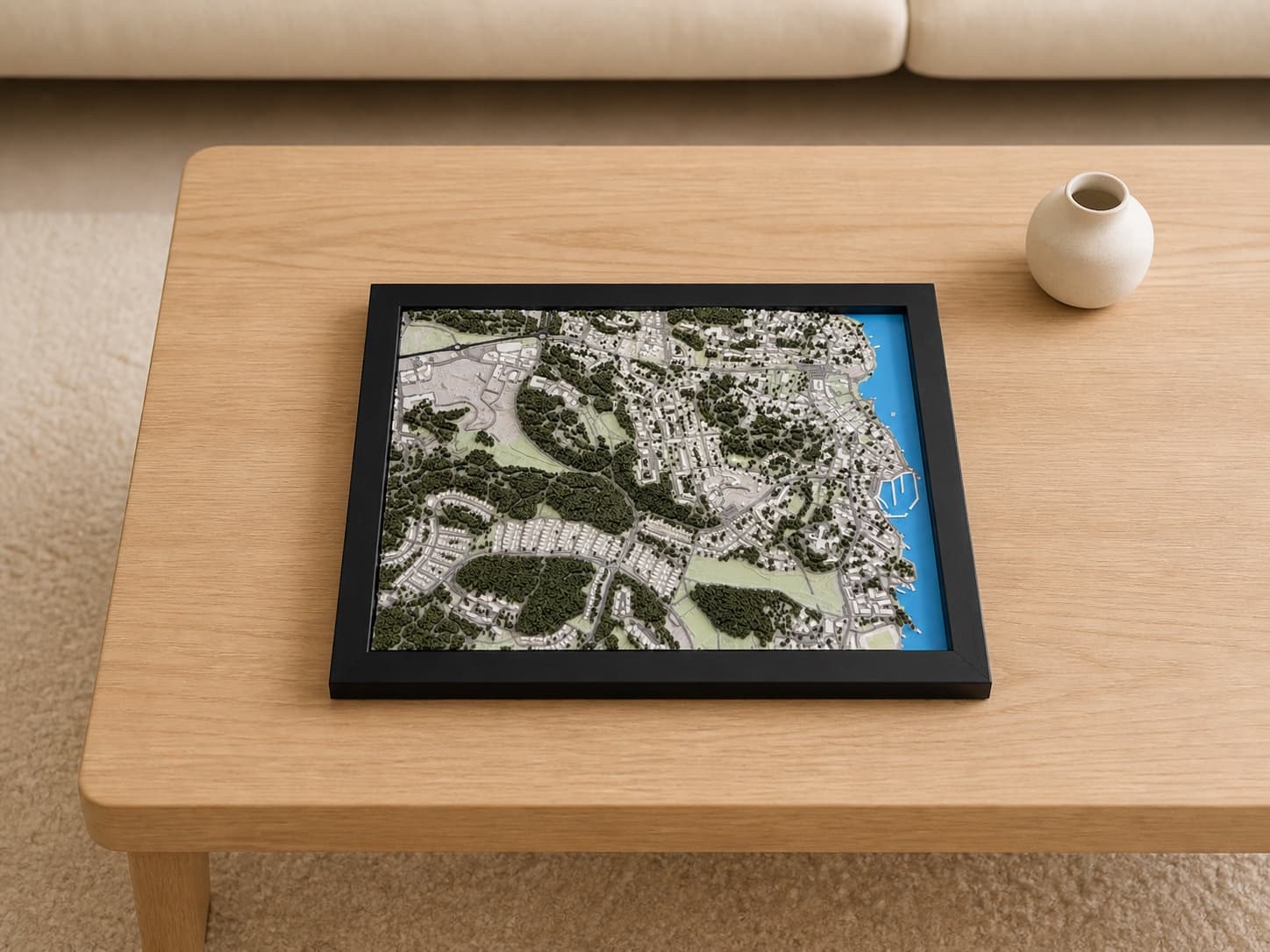 Black-framed 23 × 17 cm 3D city map of Sigtuna with woodland, streets, and shoreline.