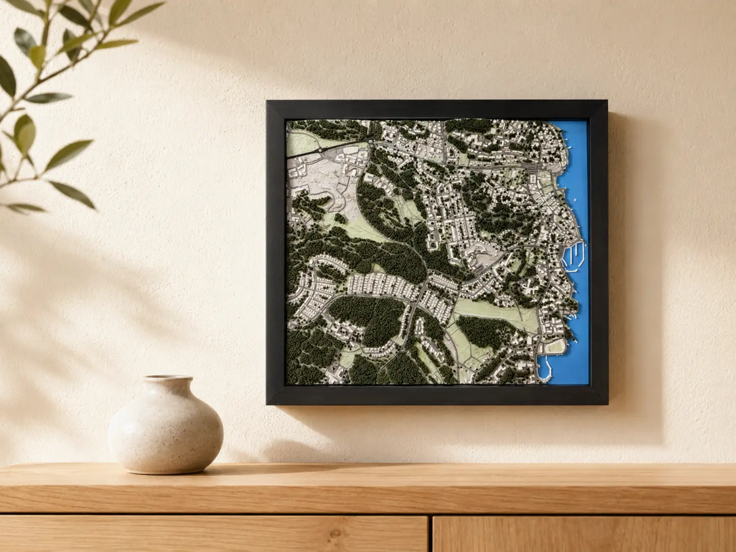 Square black-framed 3D relief map of Sigtuna with woodland, streets, and shoreline.